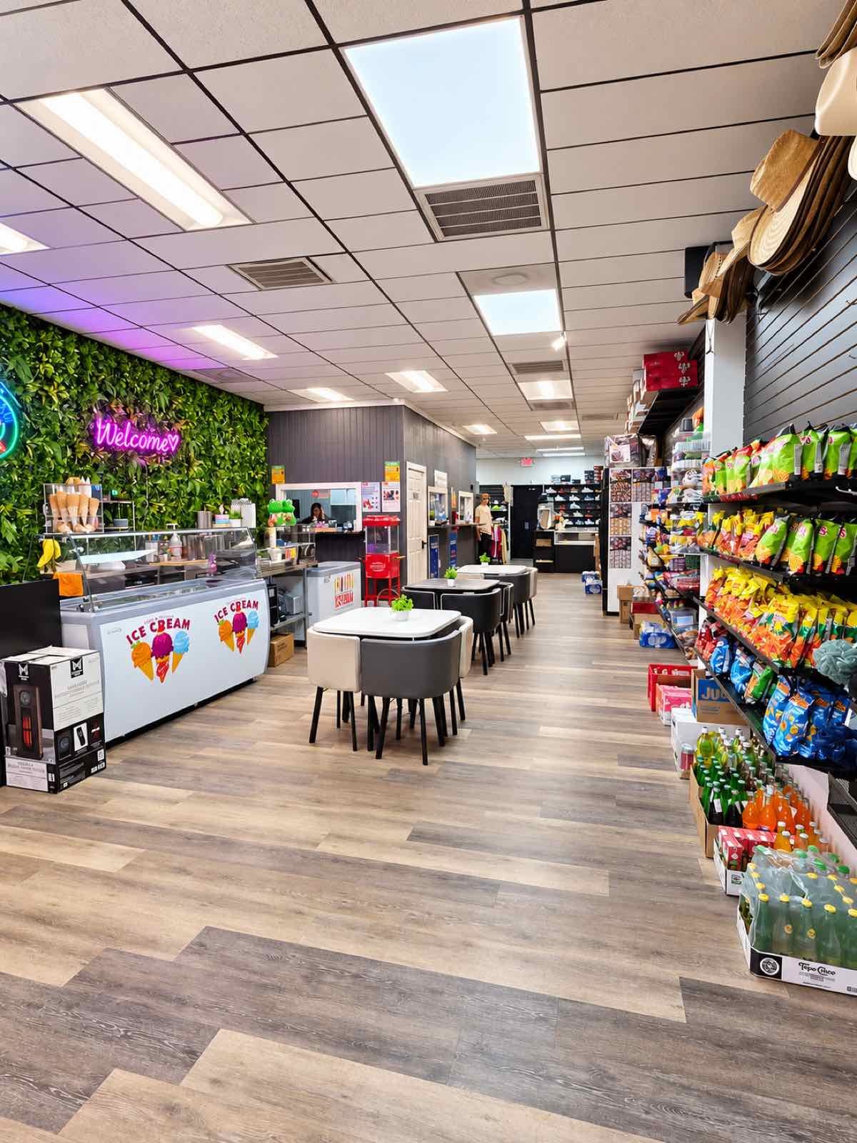 Interior de La Mía Latina con pasillo de productos, zona de helados y mesas